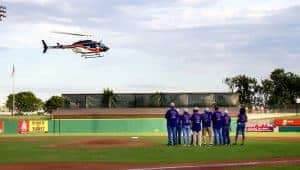 Stroke survivors wait on the baseball diamond as the helicopter prepares to land in the outfield and deliver the Strike Out Stroke baseballs to them to throw. 