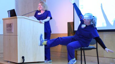 During a short break at the STOP Alzheimer's Forum, instructors lead the audience some exercises that can be done while seated. Activity and fitness are important in combating some of the effects and symptoms of dementia.