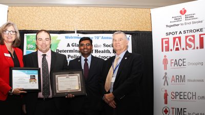 Along with officials from the Arkansas Heart Association and the Arkansas Department of Health, Matthew Mitchell, M.N.Sc., R.N., second from left, displays the awards the UAMS Stroke Program recently won.