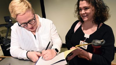 MK Czerweic, R.N., who uses the pseudonym Comic Nurse, signs a copy of her book for workshop participant Caroline Barham.