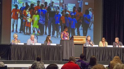 A panel of AR SAVES stroke survivors discuss their experiences during the Telestroke Conference in May in Hot Springs as a slide show behind them illustrates their stories and the history of the program.
