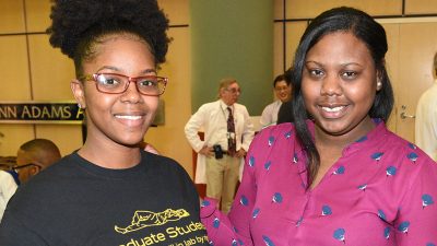 Johnsasha and Kimberly pose for photo