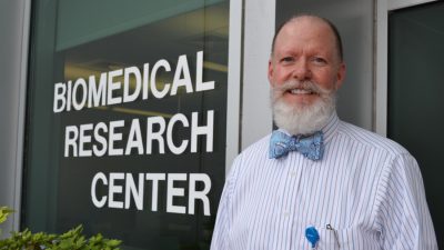 Dr. Mayeux outside of biomedical building