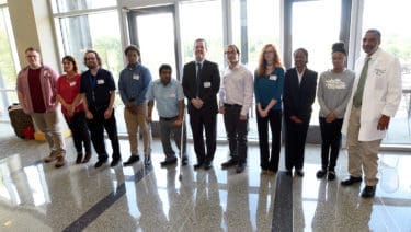 Chancellor Cam Patterson (center) and Billy Thomas, M.D., (right) vice chancellor for diversity, pose for a photo with the new UAMS Project SEARCH interns.