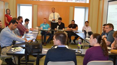 Mark Jansen, M.D., standing center, speaks to a group of first-year residents.