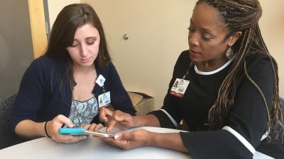 Researcher and research assistant with phone