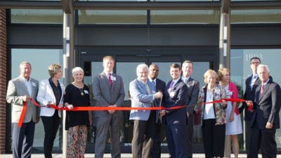 Dennis Moore, Pharm. D., and Jordan Weaver. M.D., prepare to cut the ribbon and officially open the new Family Medical Center in Batesville.