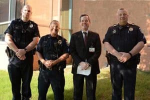 Chancellor Cam Patterson (second from right) poses for a picture with the UAMS police officers and veterans who served as the color guard. (From left) Officer Michael Murphy, Sgt. Greg Oginski and Sgt. Will Brents.