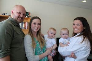 Doctor with babies and parents
