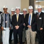 UAMS Chancellor Cam Patterson, M.D., MBA (center) attended the groundbreaking ceremony and received a hart hat. To his left is Toni Middleton, M.D., with Sterling Moore at far left; to his right are Mark Deal (center, back row), Wesley Trussell, JRMC assistant vice president for facilities and support, and Brian Thomas (right of Trussell), JRMC CEO.