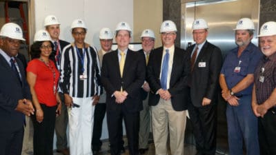UAMS Chancellor Cam Patterson, M.D., MBA (center) attended the groundbreaking ceremony and received a hart hat. To his left is Toni Middleton, M.D., with Sterling Moore at far left; to his right are Mark Deal (center, back row), Wesley Trussell, JRMC assistant vice president for facilities and support, and Brian Thomas (right of Trussell), JRMC CEO.