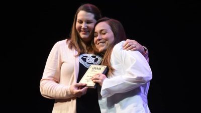 Melissa Clark, Pharm.D., M.P.H., hugs class President Ada Sochanska after presenting her with the Faculty Gold Key award.