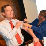 Chancellor Cam Patterson, M.D., MBA, gets his flu shot during his Sept. 17 Town Hall meeting.