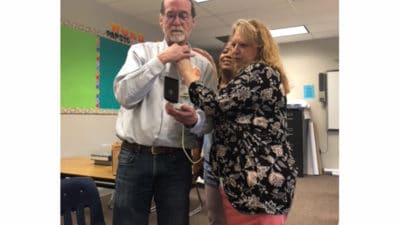 Dr. Phelan with ultrasound machine to neck