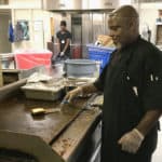 Wendell Foster, a Nutrition Services chef who prepares meals for patients, cooks a hamburger. On Oct. 2, patients will be able to order room service.