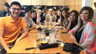 Dean Keith Olsen, Pharm.D., center, gets ready to share a meal with the six students from Kaohsiung Medical University in this year's exchange and guests.