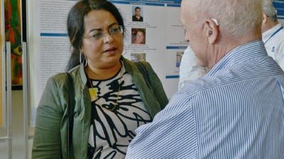 People talking and looking at posters