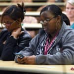 Employees used their cellphones to answer survey questions during the Vision 2029 Town Hall.