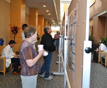 During a conference break, attendees at the Geriatric Update examine some of the 16 research posters on display at the Reynolds Institute.