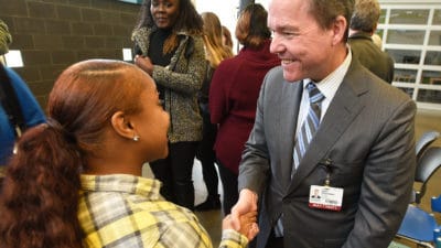 Chancellor shaking hands with woman