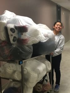 Thelma Juarez with donations from all over campus, including large plastic bags in which to transport collected blankets.