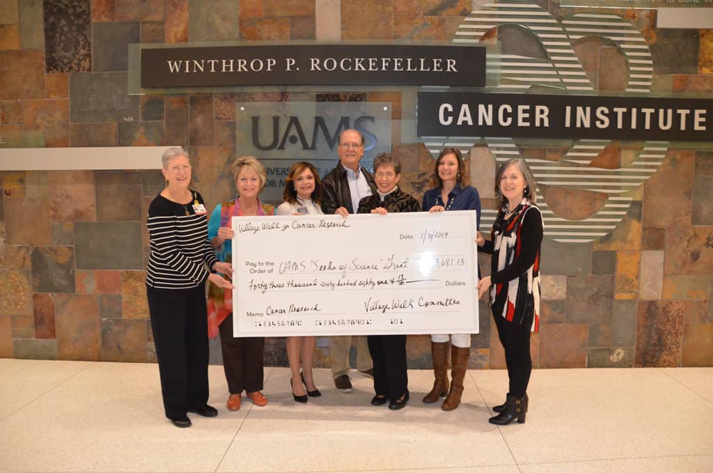 Volunteers from the Hot Springs Village Walk for Cancer Research present funds for the Seeds of Science small grant award to Samantha Kendrick, Ph.D. (second from right). Also pictured (from left) are Cancer Institute Interim Director Laura Hutchins, M.D.; Christy Etheridge; Donna Aylward; Bob Hebert; Lynne Border; and Melanie Pederson. Kendrick's co-investigator Brendan Frett, Ph.D., is not pictured.