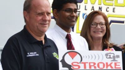 Renee Joiner, AR SAVES director, right, Sanjeeva Reddy Onteddu, M.D., AR SAVES medical director, and Ken Kelly, CEO of ProMed ambulance company in El Dorado, stand in October in front of Medical Center of South Arkansas, an AR SAVES network site.