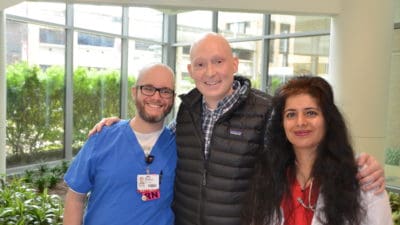 Third-year UAMS College of Medicine student and cancer survivor Corbin Norton (center) with his medical oncologist Rashmi Verma, M.D., (right) and nurse Jason Guenther, R.N.