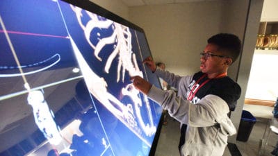 Visiting students learn about skeletal structure during STEAM Revolution at UAMS.