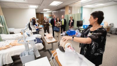 Michelle Gonzales leads a tour of the nursing simulation center during the Dean's Circle reception.