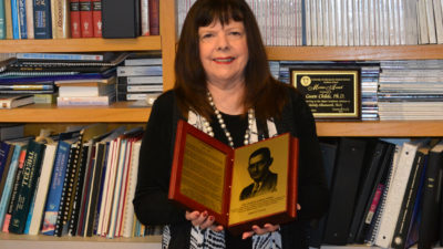 Portriat of Dr. Childs with award