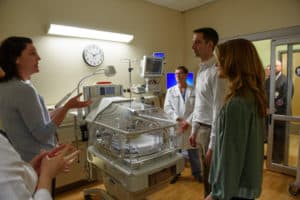 Sara Peeples, M.D. talks to the Cottons about the elements of a UAMS NICU room. 