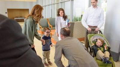 UAMS Chancellor Cam Patterson, M.D. greets the Cotton family as the prepare to tour the NICU.