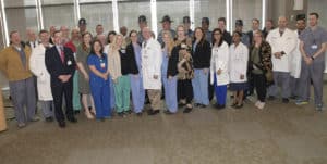 UAMS Chancellor Cam Patterson stands with the doctors, nurses, state troopers and Lila McWilliams after the ceremony to thank UAMS.