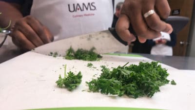 Student chops parsley in class.