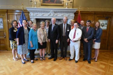 Appearing with Gov. Asa Hutchinson are (l-r), Pamela Christie, Kristin Zorn, M.D., Clare Nesmith, M.D., Betty Fortner, Laura James, M.D., Sherry Courtney, M.D., Hutchinson, Barry Brady, Amy Jo Jenkins, Thomas Burrow, M.D., David Avery, Rohit Dhall, M.D., and Stacie Jones, M.D.