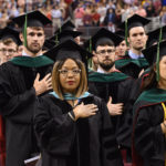 Sharanda Williams (center), director of Academic Affairs in the UAMS College of Medicine, stands as marshal with students ready to receive their diplomas.