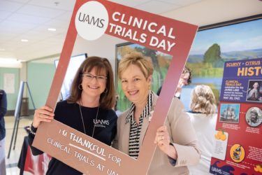 Darri Scalzo, UAMS research compliance officer, and Laura James, M.D., director of the UAMS Translational Research Institute, help celebrate Clinical Trials Day.