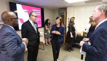 Maurice Rigsby, left, Curtis Lowery, Rosenworcel and Chancellor Cam Patterson talk at the start of the FCC commissioner's recent tour of the UAMS Institute for Digital Health & Innovation.