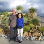 Portrait of Gerry Dienel and Nancy Cruz outside, surrounded by desert plants