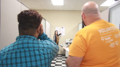 UAMS volunteers administer a vision screening for a Special Olympics athlete.