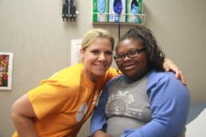 Camie Powell of Special Olympics Arkansas, with athlete Julie Grantham getting her physical.