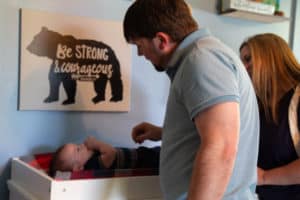 Rickie Bratton talks to his son in the nursery. 