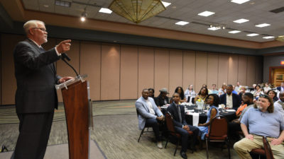 Dr. McGehee at the podium, with part of crowd visible