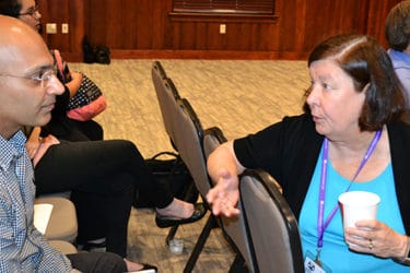 Nancy Gray, Ph.D., right, visits with a student at the boot camp just before the teams make their presentations.
