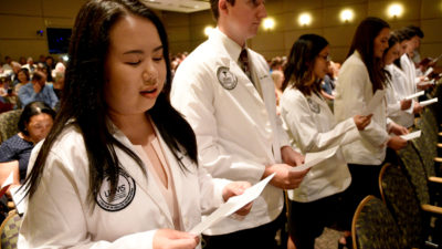 Students from the Physician Assistant Studies Class of 2021 recite the Physician Assistant Professional Oath during a May 24 white coat ceremony.