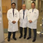 Portrait of Pothineni, Mehta, and Saad in a clinical hallway