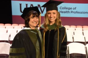 Stephanie Gardner, Pharm.D., Ed.D., senior vice chancellor for academic affairs and provost, served as the keynote speaker at her daughter's hooding ceremony. Erica Suzanne Gardner (right) graduated with a Doctor of Audiology.