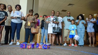 Student-built robots battles for an audience at the conclusion of the UAMS NERDIES Health Sciences Camp.