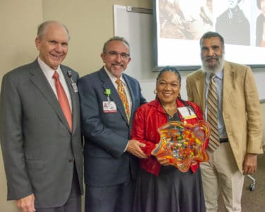 College of Medicine Dean Christopher Westfall, M.D., FACS, Erick Messias, M.D. and Billy Thomas, M.D., present the COM Dean's Distinguished Alumni Award to Myra Jones Romain, who accepted on behalf of her late mother, Edith Irby Jones, M.D., COM '52.